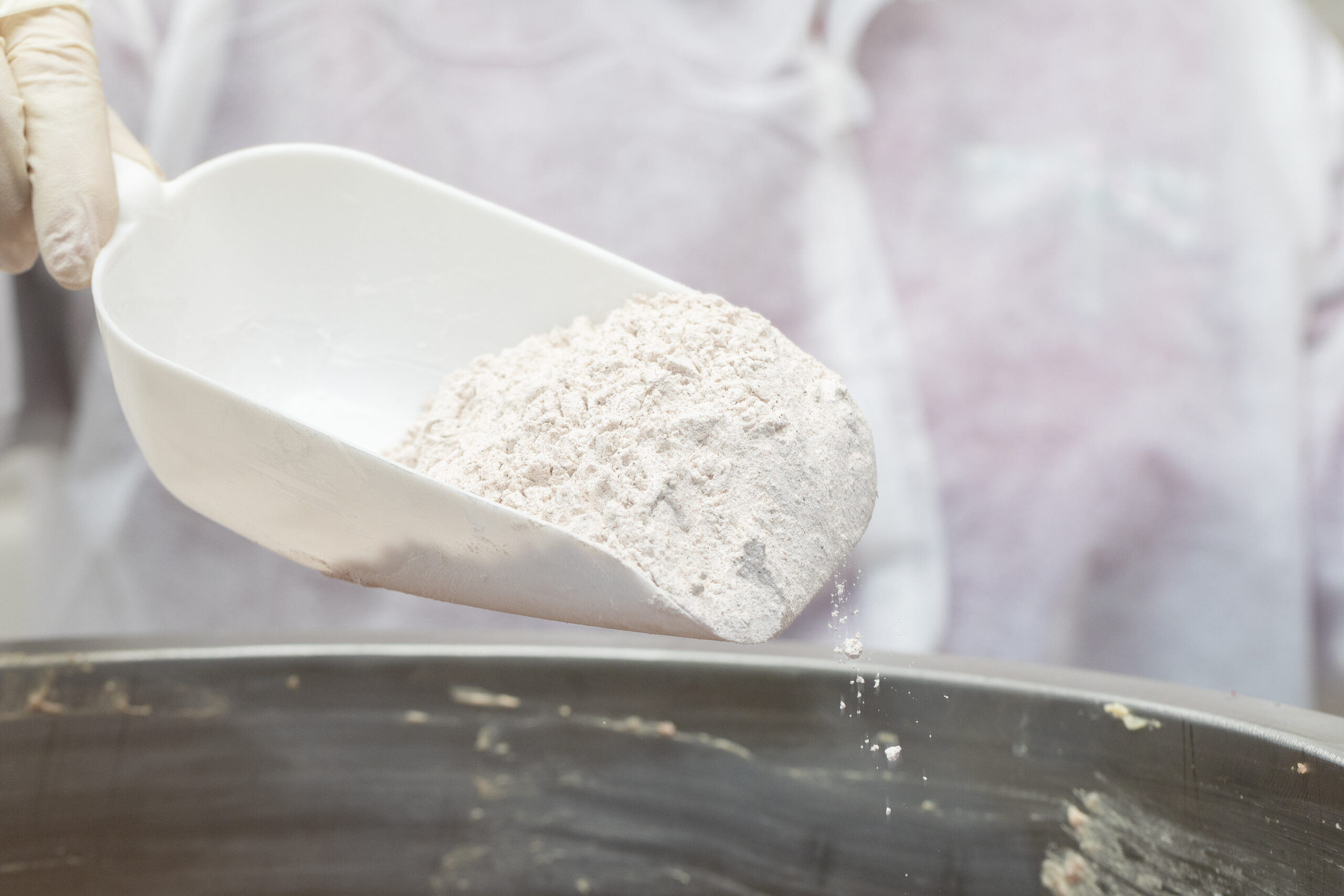 Adding flour into frying metallic pan. High quality photo